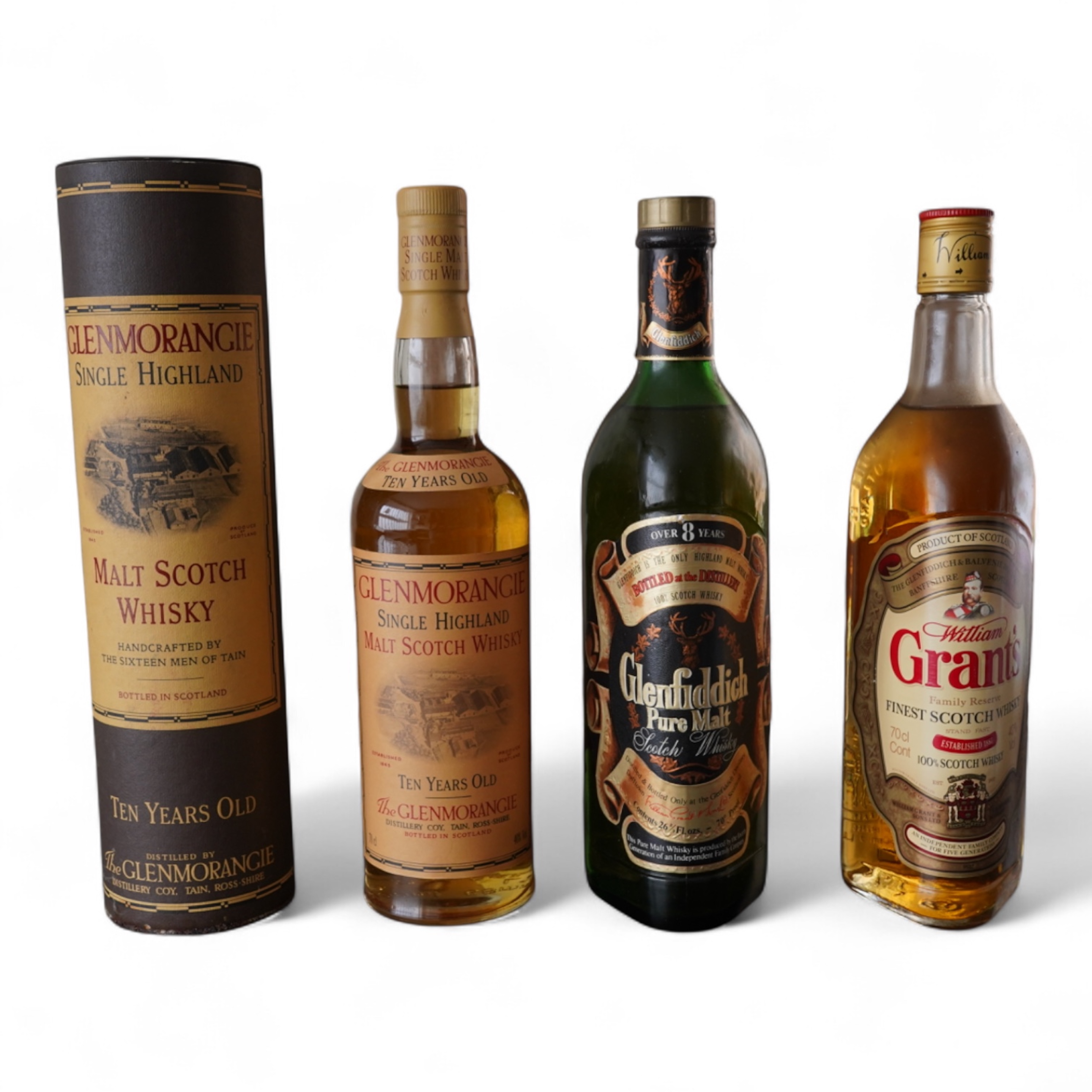 Three bottles of malt whisky: Glenmorangie, Glenfiddich and Grants